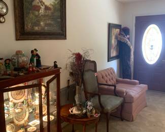 Curio cabinet packed with collectibles, very comfortable vintage furniture, mid century Karastan thick pile rug