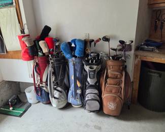 Several sets of used golf clubs