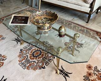 Manner of Jansen brass ram head and glass coffee table