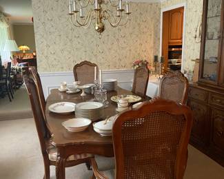 Large vintage dining table with two captain chairs and four side chairs.