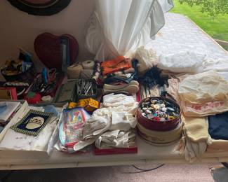 Lots of vintage sewing items and linens.