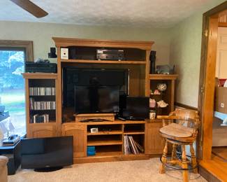 Nice 3-pc wall unit, entertainment center. Will fit a 54" television. Bar stool is just one of the five available. Several Samsung flat screen TV's.