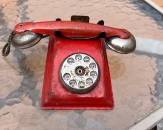 Antique toy tin rotary phone.
