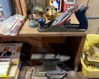 Vintage oil, cans, wood plane, antique iron and workbench.