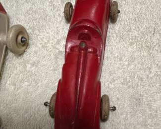 This is an arcor place safe Toy product made in the USA. This is a streamline racer, almost backwards looking Futuristic automobile. This is not cast iron but more of a rubberish material.