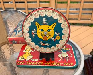 Antique tin toy bingo pinwheel called “The ranger animal fair”.