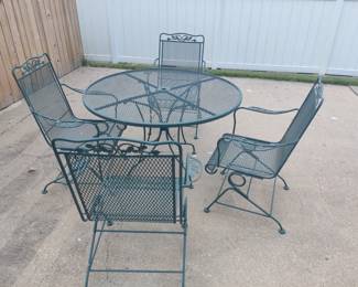 WROUGHT IRON PATIO TABLE AND FOUR SPRING ACTION CHAIRS $125