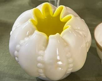 Fenton Yellow Overlay Beaded Melon Rose Bowl. It's a vintage piece of Fenton art glass, specifically a rose bowl vase.
Here is some information about the item:
Style: This item is in the "Beaded Melon" pattern and features a yellow overlay on white milk glass. It often has a crimped or ruffled edge.
Origin and Era: It is likely from the mid-20th century, potentially the 1950s, and possibly made only in the later half of 1956. Fenton Art Glass is a well-known manufacturer of collectible glass, and this type of piece would have been handcrafted.
Collectibility: These rose bowls, especially with the yellow overlay, can be considered rare. They are popular items for collectors of Fenton art glass.
Appearance: The bowl is round and has a glossy finish. The beaded pattern adds a unique texture. The yellow interior is prominent. This would be a valuable addition to a Fenton glass collection.
$45