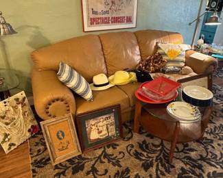Leather couch, ladies, hats, various pictures, and plates. 