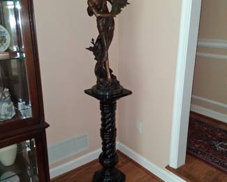bronze figure on marble pedestal