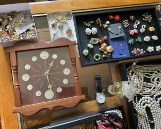 Costume jewelry, silver coins in a clock