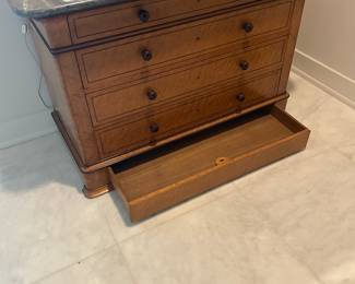 $2,000. Antique, early commode with lower hidden drawer, could be Biedermier. Grey marble top, 35” tall, 51.5” wide, 23.5” deep.