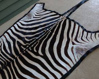 $350. 10’6” x 6’ authentic zebra pelt rug with felt backing