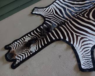 $350. 10’6” x 6’ authentic zebra pelt rug with felt backing