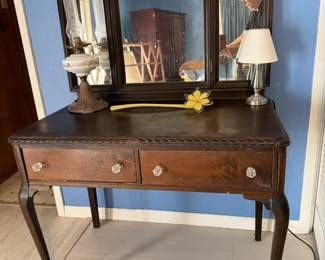 Antique dressing table with mirror. Antique oil lamp. Desk lamp