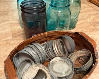Example of canning jars and lids: White, green, purple, and blue glass jars with zinc/metal and ceramic/glass lids