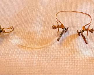 rimless spectacles / eyeglasses. Made of 10k gold filled material, they also have a Ketcham & McDougall Retractable Chain. The glasses have a patent date of July 1896.
