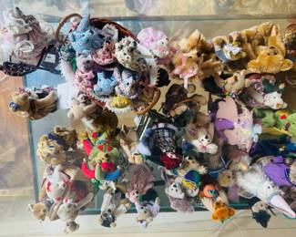 In this case alone, there are over 60 miniature vintage bears made and signed by artists. The bears are from the 80’s, 90’s and early 2000.  Most are a collection from the world of miniature bears.  There are many more! 