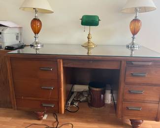 Antique glasstop desk with lamps front view