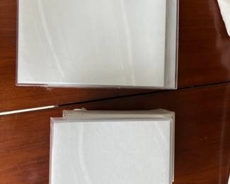 Dozens of acrylic photo frames.