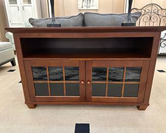 Very nice heavy duty media center, its vented for serious equipment with cut-outs for wiring. It's 50" long for large TV's, and adjustable shelves on two sides. It's in awesome condition.