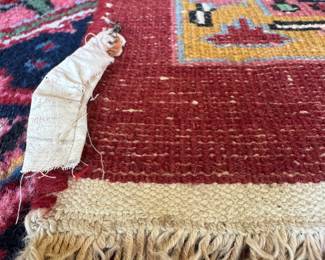 $1600; wool, knotted rug with vibrant red, blue, gold and pinks; 9'x11'; close up view of the knotting