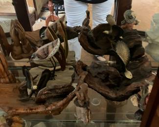 An assortment of wooden birds on branches