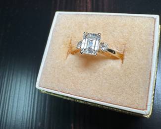 Engagement ring, 14 k with emerald cut diamond, and 2 round brilliant cut diamonds.