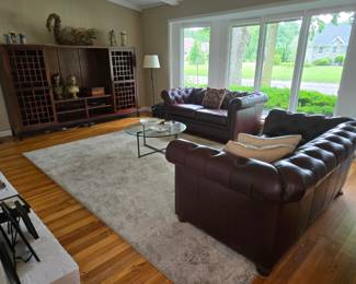 Pair of matching leather Pottery Barn chesterfield sofas and a beautiful entertainment cabinet with sliding doors