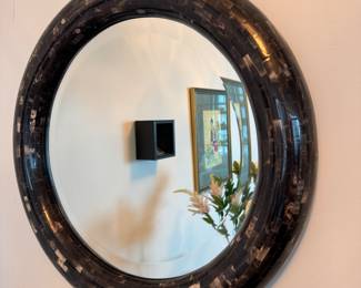 round wall mirror with a mosaic horn-style frame