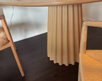 Style: Modern/Scandinavian-inspired
Base: Vertical fluted or scalloped pedestal
Top: Round, smooth surface, likely veneer over composite or solid wood
Color: Light natural wood tone