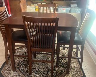 Pub table with 4 accompanying chairs.