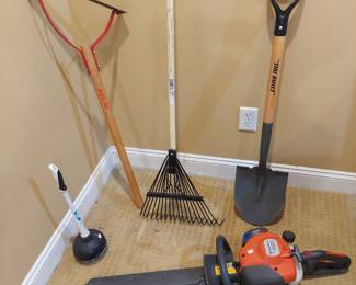 assortment of tools including a gas powered hedge trimmer