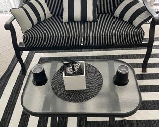 Black and white patio furniture and rug