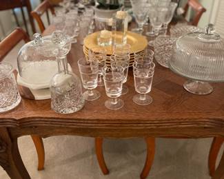 Forty Year Old Reproduction of French Antique formal dining table and chairs. Seats up to twelve People. Dining filled with crystal and entertaining serving pieces