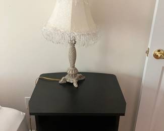 white metal table lamp with fringed lampshade