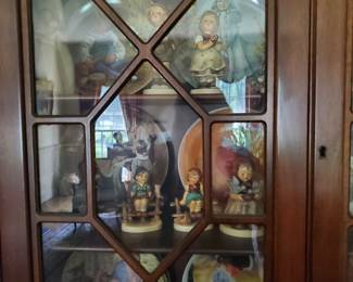 A secretary in the Living Room filled with Hummel's. There are more! Find your favorites!