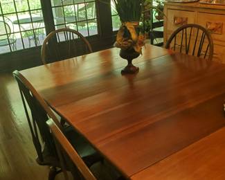 This table has a leaf and the six chairs are sold separately. The chairs are Nichols and Stone Co.
