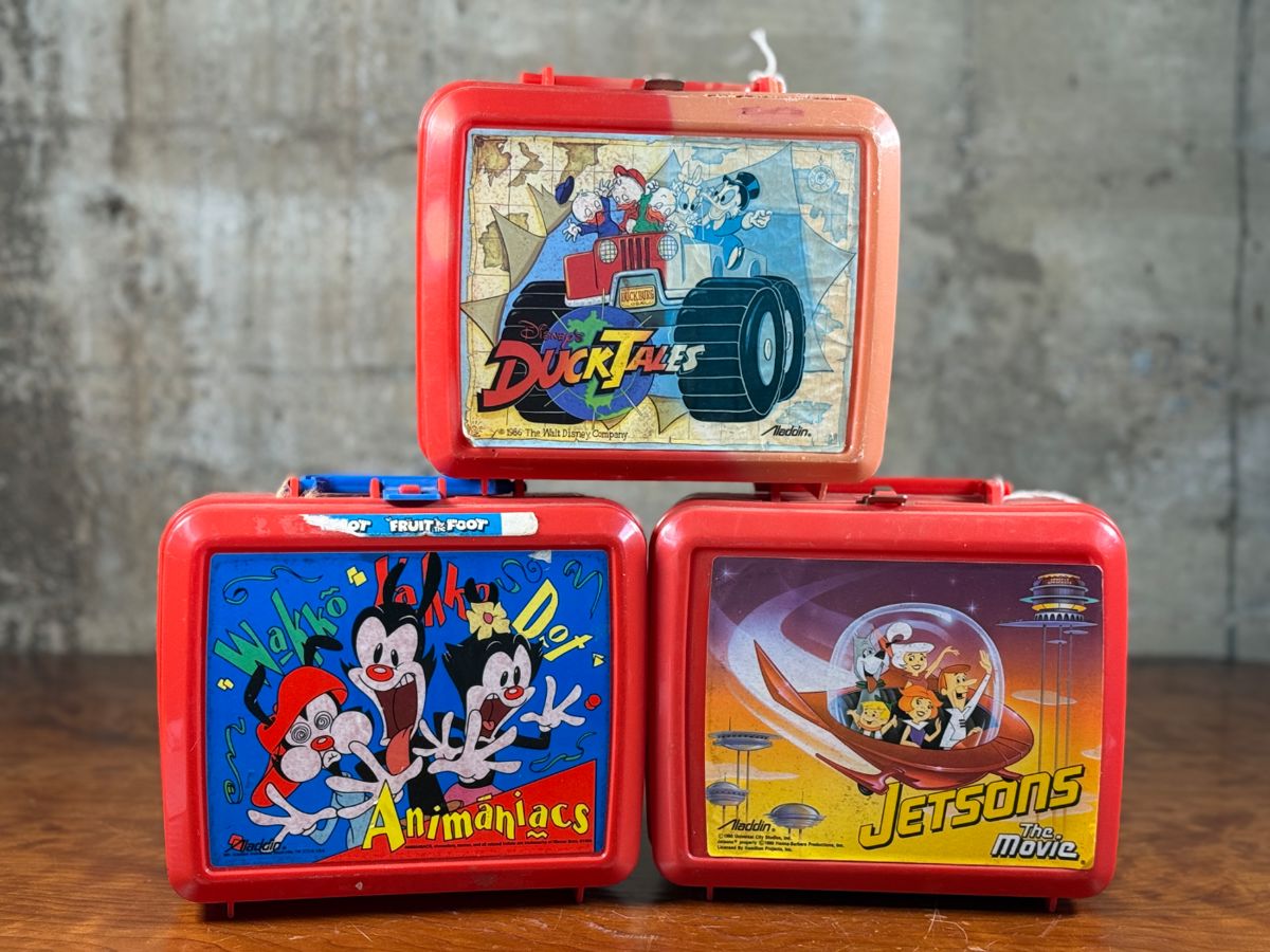 This lot features a collection of three vintage lunchboxes. Two comes with the original Thermos. 