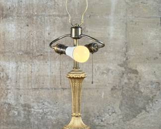 This lot features an early 20th century gilt metal lamp in good working condition. A beautiful lighting accent. This early 20th century gilt metal lamp measures, 29” H x 8” W x 8” D.