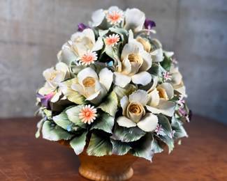 This lot features a large floral arrangement center piece, manufactured by Capodimonte. This arrangement measures, 13” H x 12” W x 12” D. Capodimonte porcelain, soft-paste porcelain produced by a factory established in 1743 at the Palazzo of Capodimonte by Charles III of Naples. Ware was produced there in large quantity and wide variety until 1759, when the concern was dismantled and removed to Buen Retiro, near Madrid, when Charles became king of Spain. This item appears to be in very good condition. No in-house shipping available.