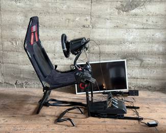 This lot features a Next Level racing simulator and Samsung monitor. Everything comes untested, but appears complete with additional mounts and accessories. The Samsung monitor does contain a minor scratch, visible in photos.