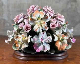 This lot features a large floral arrangement center piece, manufactured by Capodimonte. This arrangement measures, 10” H x 13” W x 9” D. Capodimonte porcelain, soft-paste porcelain produced by a factory established in 1743 at the Palazzo of Capodimonte by Charles III of Naples. Ware was produced there in large quantity and wide variety until 1759, when the concern was dismantled and removed to Buen Retiro, near Madrid, when Charles became king of Spain. This item appears to be in very good condition. No in-house shipping available.