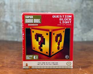 This lot features a new old stock “Question Block Light” by Nintendo. Appears to have never been taken out of the box. Comes untested.