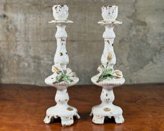 This lot features a pair of Capodimonte candleholders. Each candle holder measures, 14.5” H x 4.5” W x 4.5” D. Capodimonte porcelain, soft-paste porcelain produced by a factory established in 1743 at the Palazzo of Capodimonte by Charles III of Naples. Ware was produced there in large quantity and wide variety until 1759, when the concern was dismantled and removed to Buen Retiro, near Madrid, when Charles became king of Spain. No in-house shipping available. Little to no flaws on the pair, with minor wear.