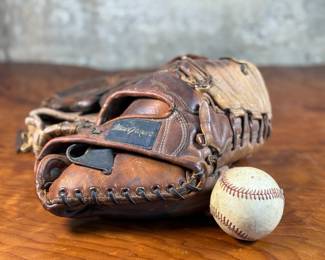 This lot features three vintage baseball gloves and a baseball.