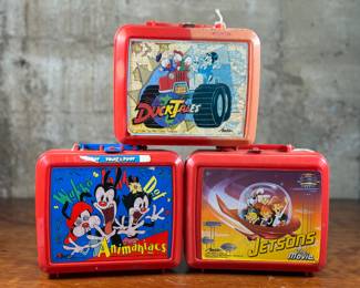 This lot features a collection of three vintage lunchboxes. Two comes with the original Thermos.
