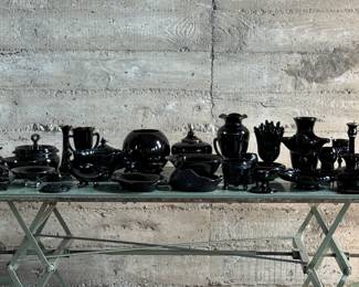 This lot features forty-six (46) assorted pieces of black amethyst glass. Included are vases, bowls, candle holders, and so much more. Majority appear to be in very good condition.