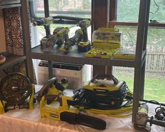Table set up of Ryobi tools and batteries for sale