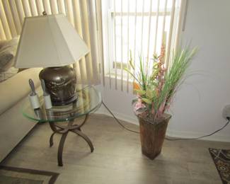 glass top side table and faux plant in vase